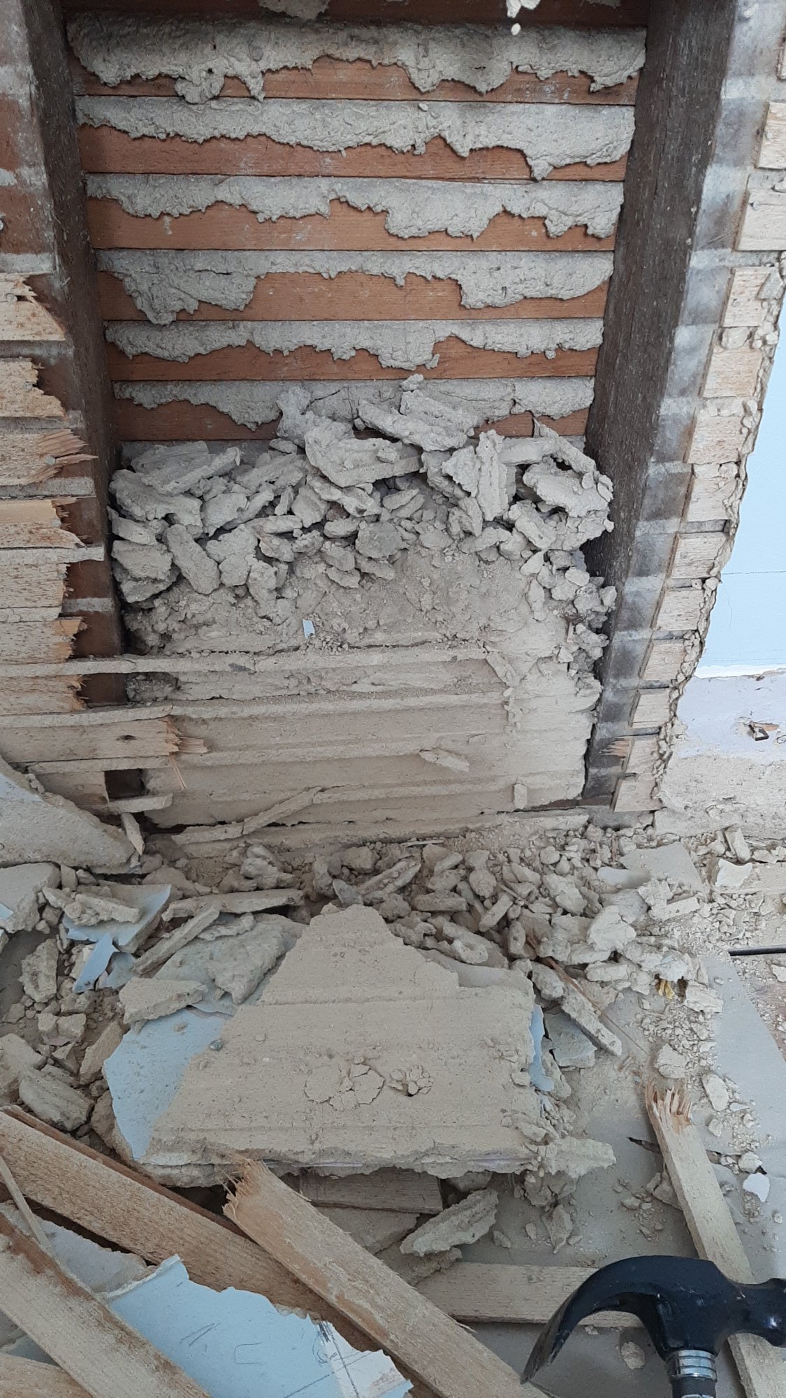 Demolishing the old lath and plaster wall creating lots of dust