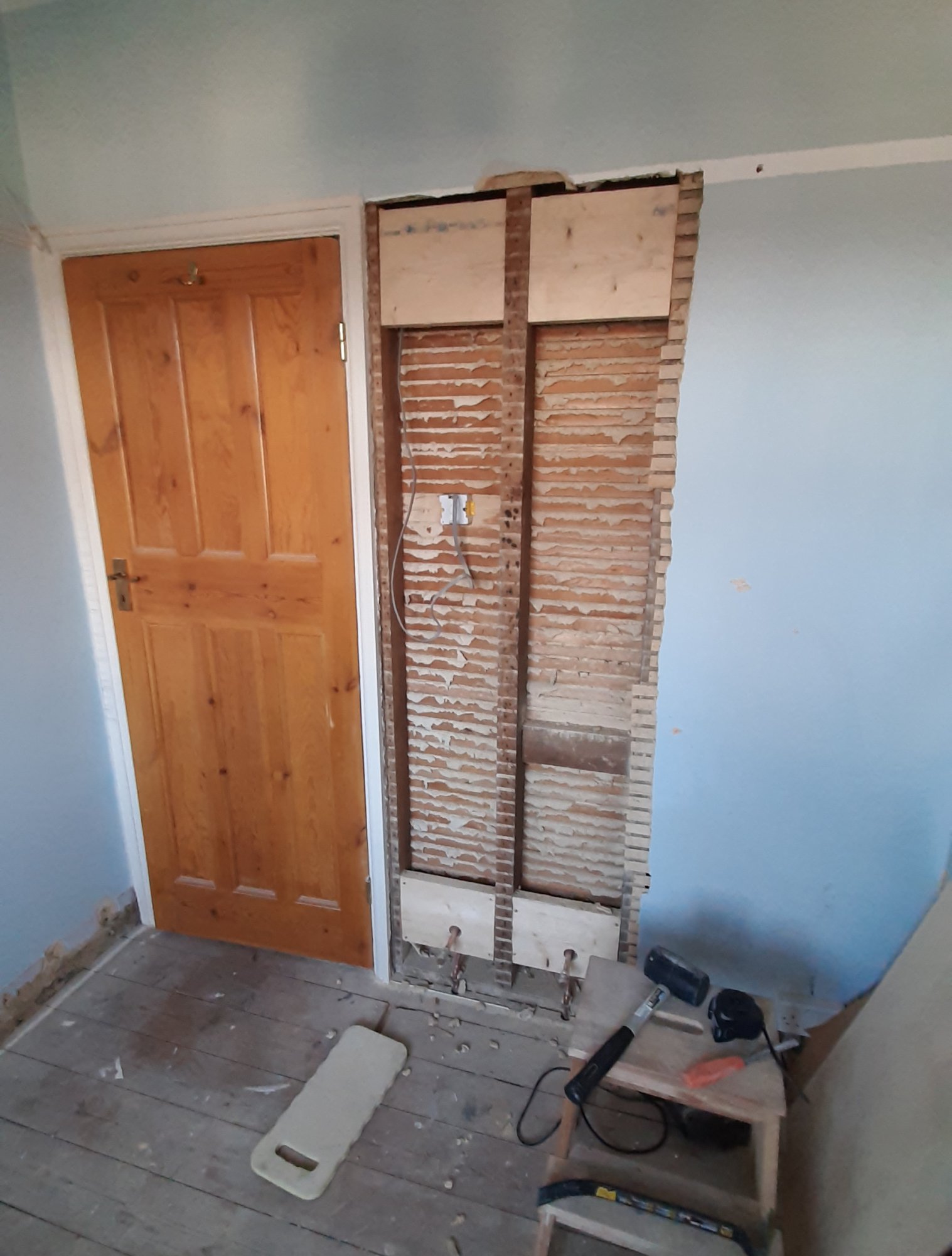 The old plaster removed and new wooden noggins added to reinforce the wall